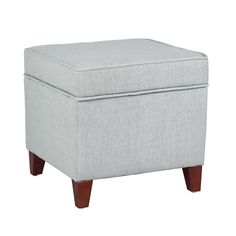 a light gray ottoman with wooden legs