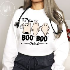 Funny Nurse Sweatshirt or Shirt - The Boo Boo Crew Introducing our hilarious and spooky "The Boo Boo Crew" Halloween shirt, designed especially for all types of nurses! Get ready to spread laughter and Halloween spirit with this delightful shirt featuring retro ghosts holding medical tools. Crafted with high-quality materials, this shirt ensures utmost comfort and durability for long hours at work or festive celebrations. Whether you're a nurse looking for a lighthearted way to showcase your ded Halloween Nurse Tshirt, Halloween Nurse Sweatshirt, Medical Halloween Shirts, Boo Boo Crew Shirts, Costumes For Nurses At Work Halloween, School Nurse Tshirt Ideas, Halloween Crew Neck Top With Graphic Print, White Long Sleeve Halloween T-shirt, White Long Sleeve T-shirt For Halloween