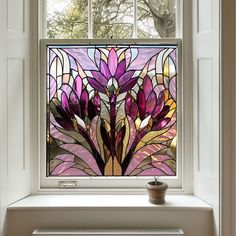 a stained glass window with purple flowers on it