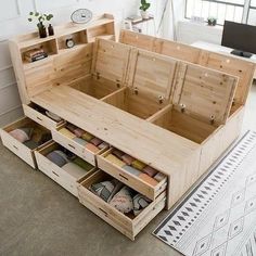 an open wooden box with drawers on the floor