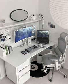 a white desk topped with two computer monitors