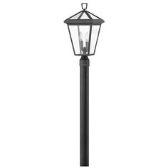 a black lamp post with two lights on top and one light on the bottom, in front of a white background