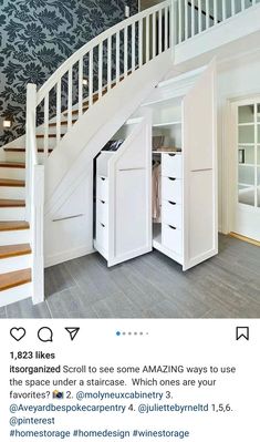 an open closet under a staircase in a house with white painted walls and wood floors