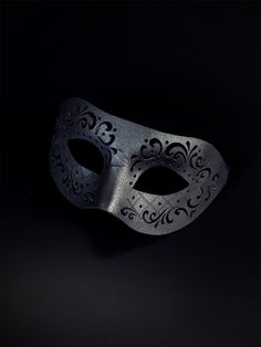 Black vegan leather masquerade mask with an engraved design. Cheap Black Themed Masks, Black Elegant Mask, Luxury Artistic Black Mask, Luxury Black Party Masks, Luxury Black Theater Masks, Luxury Black Eye Mask For Masquerade, Veil Mask Men, Black Luxury Eye Mask For Masquerade, Bird Mask Black