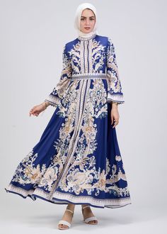 Step into timeless elegance with our Royal Blue Floral Print Satin Modest Dress, designed to elevate your wardrobe for every season. This modest dress features a luxurious satin fabric that drapes beautifully while offering comfort and sophistication. The intricate floral pattern in soft hues enhances the royal blue background, creating a striking yet graceful look. With its high neck and long kimono sleeves, this modest dress exudes a sense of classic charm. The empire waistline, accentuated wi Blue Floral Print Dress For Banquet, Blue Silk Long Sleeve Maxi Dress, Satin Modest Dress, Modest Activewear, Dress With High Neck, Royal Blue Background, Belted Maxi Dress, Full Coverage Swimsuit, Imperial Blue