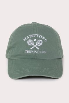 a green hat with the words hampton's tennis club on it and two rackets