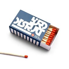 an open matchbox with matches on the side