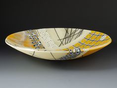 a yellow and white bowl sitting on top of a table