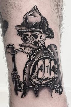 a man's leg with a skull wearing a fireman hat and holding a scooter