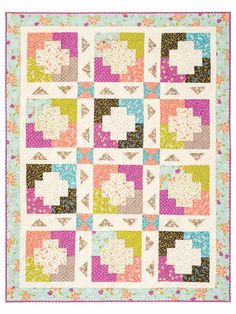 a colorful quilt with squares and flowers on the front, in pastel colors that appear to be made out of fabric