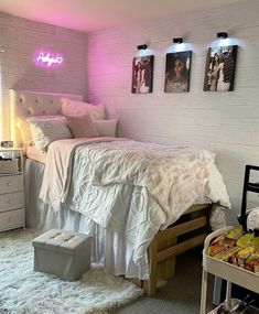 a bed room with a neatly made bed and some pictures on the wall above it