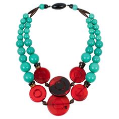 Angela Captui, Italy, designed this outstanding resin-beaded necklace. The choker color is predominantly teal green with a striking contrast of red and black. Each rounded pebble bead is carved and dimensional. Her color matching is always extremely classy, perfect for casual or fancy occasions. As you know, Caputi jewelry is not signed. This pre-owned necklace still has its brand-signature snap-closing clasp, although the plastic tag was removed. Angela Caputi has produced resin and Lucite jewe Unique Red Necklace With Colorful Beads, Unique Red Necklace With Large Beads, Red Oval Beaded Hand-strung Necklace, Artisan Red Collectible Necklaces, Artisan Multi-strand Red Necklaces, Lucite Jewelry, Black Pebbles, New York Museums, Teal Green