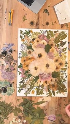 someone is working on an art project with flowers