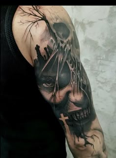 a man with a skull and cross tattoo on his arm