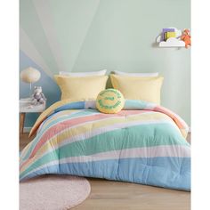 a child's bedroom with blue, yellow and pink striped comforter on the bed