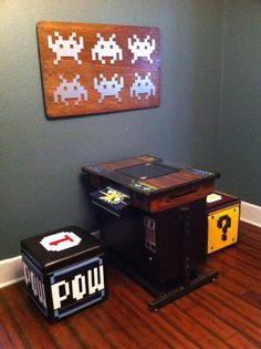 two video game tables sitting on top of a hard wood floor