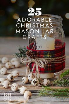 a mason jar filled with christmas decorations on top of a wooden table next to pine cones