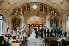 a bride and groom are standing at the alter in front of their wedding ceremony guests