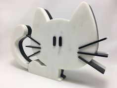 a close up of a cat shaped object on a white surface