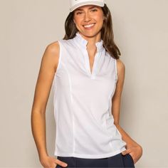 Everyone's favorite ruffle collar top is now in a fantastic new performance recycled mesh! This sleeveless v-neck top has been a perennial favorite at Ellie Day, and we are sure you'll love this new crisp white version. Made for women, this sleek shape takes the bulk out of getting dressed for an ambitious day! Our high-cut armholes are extremely flattering, and the body length is great for leaving untucked. Our performance mesh ruffle collar top is breathable, moisture-wicking, and quick drying, with UPF 50 sun protection. DETAILS: Designed for a slim fit: if between sizes, we recommend sizing up 100% Recycled Polyester with UPF Machine Wash Cold Available in sizes XS-XXL, shown on the model (5'11") in size small Imported Collar Sleeveless Top, Cute Golf Outfit, Ruffle Collar Top, Sustainable Style, Ruffle Collar, Collar Top, Effortless Chic, Golf Outfit, High Cut