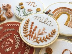 embroidered hoops with the word mum on them next to other handmade embroidery designs