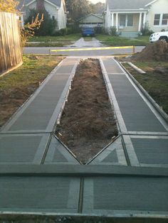 the sidewalk is being laid in front of some houses with no grass or trees on it