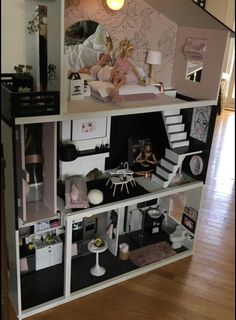 a doll house with furniture and accessories inside