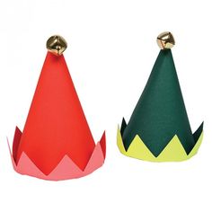 two paper hats with bells on them are shown in three different colors, one red and one green