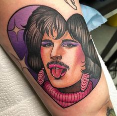 a person with a tattoo on their arm that has an image of a woman's face