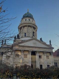 a large building with a clock on the front and side of it's tower