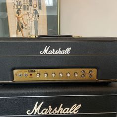 the marshall amp is sitting on top of other musical equipment