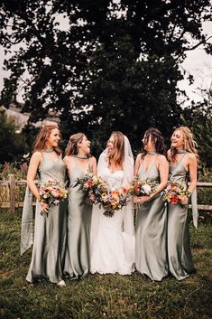 bridal party wearing green satin bridesmaid dresses Green Satin Bridesmaid Dresses, Wildflower Wedding Bouquet, Green Themed Wedding, Rainy Wedding, Mismatched Bridesmaids, Mismatched Bridesmaid Dresses