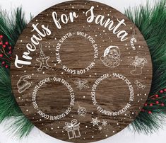 a wooden sign that says thanks for santa and other christmas related items on it, surrounded by pine branches