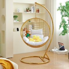 a room with a swing chair, bookshelf and shelves