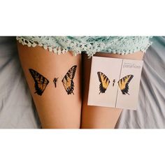 two butterflies on the legs of a woman