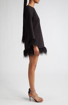 Feathered finishes bring the party to a long-sleeved dress ready to step out for the night. 29" length; 4" fringe (size 8) Jewel neck Long sleeves Lined, except sleeves 67% polyester, 27% rayon, 6% spandex Dry clean Imported Long Sleeve Mini Dress With Fringe For Party, Long Sleeve Dresses With Tassels For Night Out, Long Sleeve Fringe Dress For Fall, Long Sleeve Fringe Mini Dress For Night Out, Luxury Mini Dress For Fall Party, Fall Party Dresses With Tassels, Fall Cocktail Dress With Feather Trim, Long Sleeve Fringed Dress For Night Out, Black Mini Dress With Feathers For Fall