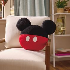 a mickey mouse pillow sitting on top of a chair