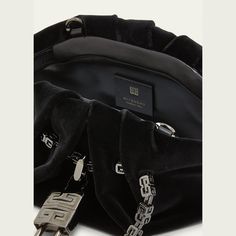 Givenchy "Kenny" top handle bag in satin silk Logo chain top handles  Detachable crossbody strap Can be worn as a top handle or crossbody bag  Ruched top with magnetic closure; padlock accent  Lining: Silk Approx. 4.3"H x 11.4"W x 4.3"D Made in Italy