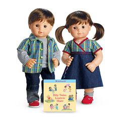 two dolls standing next to each other with a book in front of them on a white background