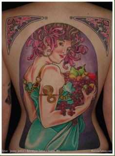 a woman with tattoos on her back holding fruit