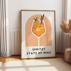 a framed poster with an orange drink and strawberries on the rim reads, spritzy state of mind