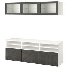 a white and gray shelf with two glass doors next to each other on the wall