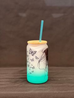 a cup with a straw in it sitting on a table