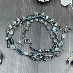 This incredible wrap bracelet has been a work in progress for a while. The combination of the pewter focal with the gorgeous 6mm flashy labradorite rounds absolutely enchanted me. From there, I added so many of my favorite things. In this bracelet, you’ll find apatite rectangles, the most insane faceted 8mm kyanite, 8mm starcut pale jade, flashy tourmilinated rainbow moonstone, smoky quartz, and the most incredible faceted prasiolite nuggets. Also featured are the prettiest faceted glass rondelles. Let’s circle back to the focal. The shape was so interesting and mysterious to me. I wrapped on faceted labradorite and iolite to bring out some of the lines. This wrap bracelet is sterling silver, with the exception of the USA made pewter focal. The knotted portion of the bracelet was done in h A Work In Progress, Bar Bracelets, Faceted Glass, My Favorite Things, Smoky Quartz, Work In Progress, Rainbow Moonstone, Wrap Bracelet, Enchanted