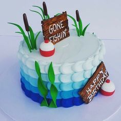 there is a cake that says gone fishin on the top and two signs above it