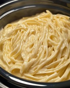 a bowl filled with pasta sitting on top of a table