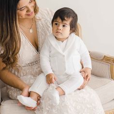 a woman sitting next to a baby in a chair