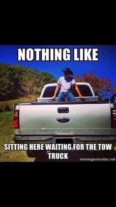 a man sitting in the back of a truck with text saying nothing like sitting here waiting for the tow truck