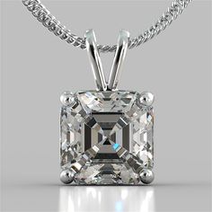 an emerald cut diamond pendant on a silver plated necklace with chain attached to it