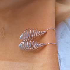 𝑯𝒂𝒏𝒅𝒎𝒂𝒅𝒆 𝒂𝒏𝒅 𝑴𝒊𝒏𝒊𝒎𝒂𝒍: Enhance your look with our dainty Silver Beehive Earrings for Women, perfect for those who are searching unique, funky and trending jewelry for their loved ones. These earrings feature Spiral Wire Teardrop Cage dangle drop earrings, Silver Plated and secure fishhook are designed to be a minimal dainty gift for various occasions, including birthdays, parties, and as Christmas gifts. DETAILS: * Cage Dangle Earrings * Silver Plated * Sold as a Pair * Comforta Spiral Wire Wrapped Earrings For Party, Wire Wrapped Spiral Earrings For Parties, Party Spiral Wire Wrapped Earrings, Spiral Wrap Earrings As Gift, Wasp Nest, Trending Jewelry, Spring Earrings, Jewelry Care Instructions, Wire Work Jewelry